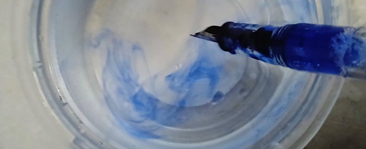 Ink clouds in the water while cleaning a fountain pen